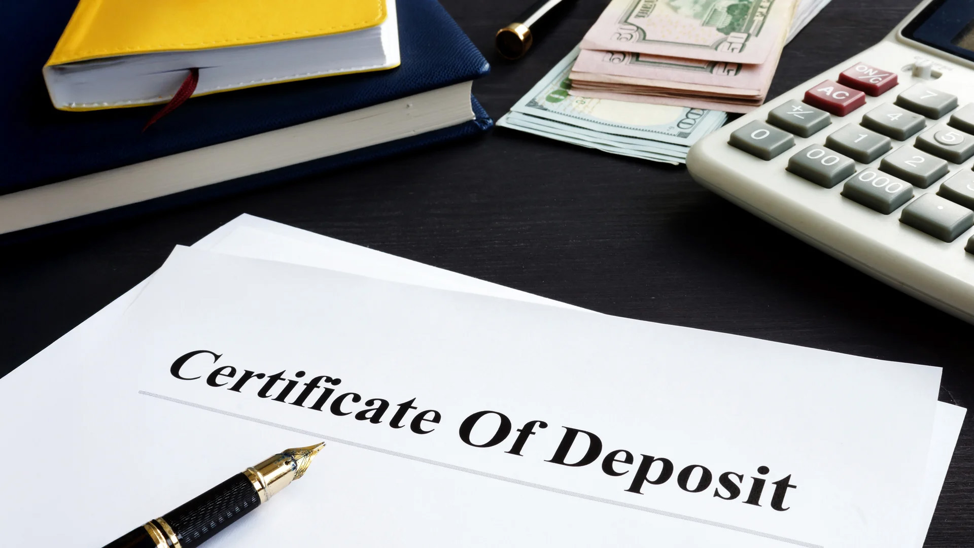 Certificate of Deposit with pen and paper