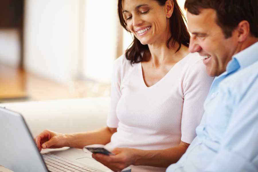 man and woman working on a computer